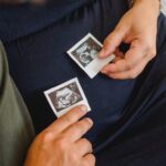 expectant mother and father with scan pictures of baby